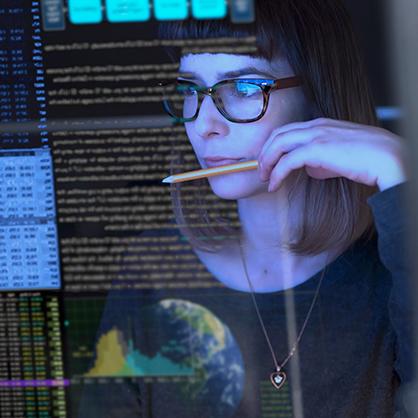 A woman working at a computer screen.